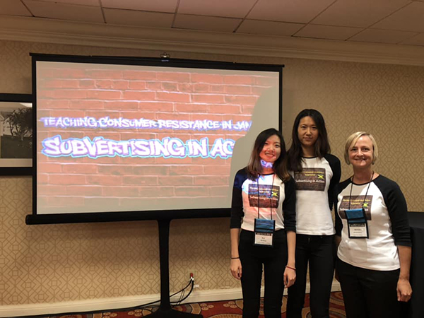 Three Women in front of powerpoint presentation